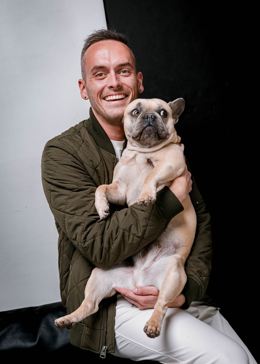 Tyler holding his fawn French Bulldog